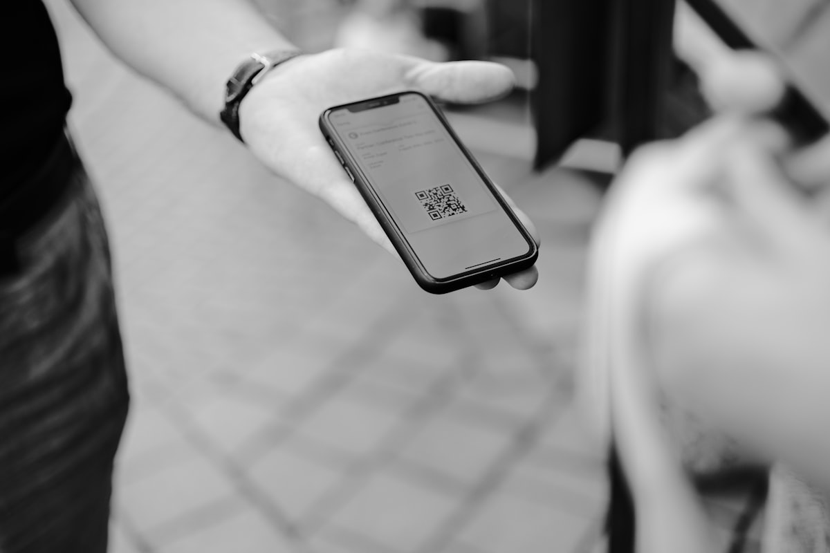 Una persona muestra en su teléfono el código QR de su boleto en la entrada.
